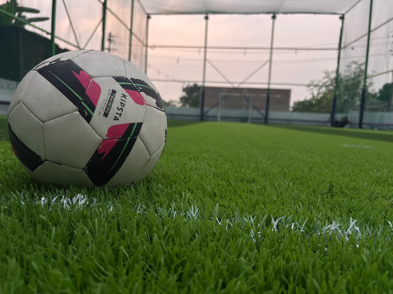 Football resting on artificial turf