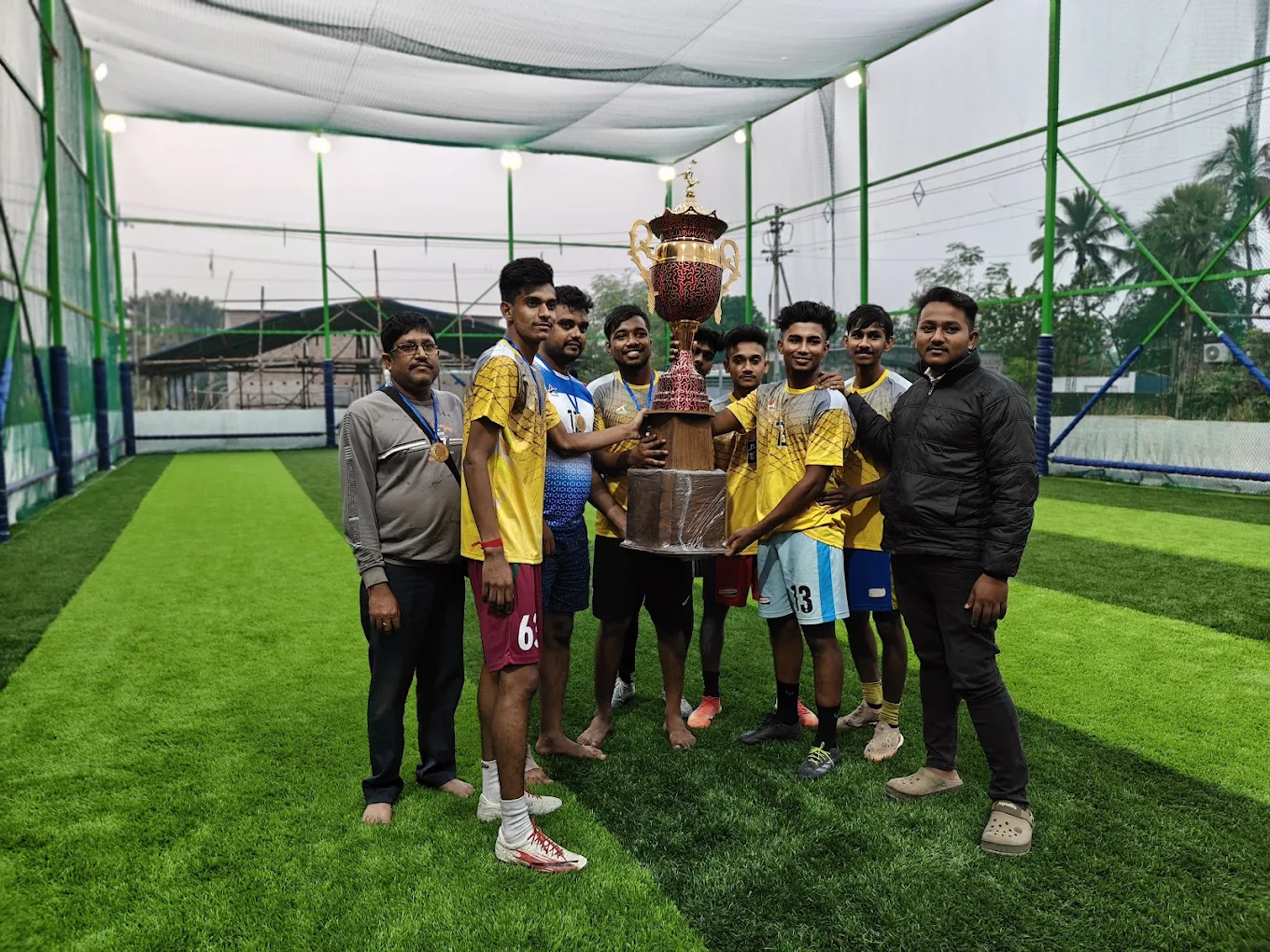 Yellow team holding a tournament trophy